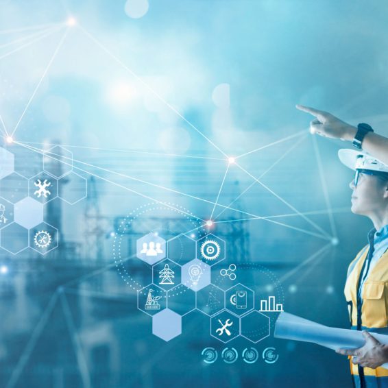 Male and female industrial engineers using tablet computer and blueprints checking and analysis data of power plant station project on network background.